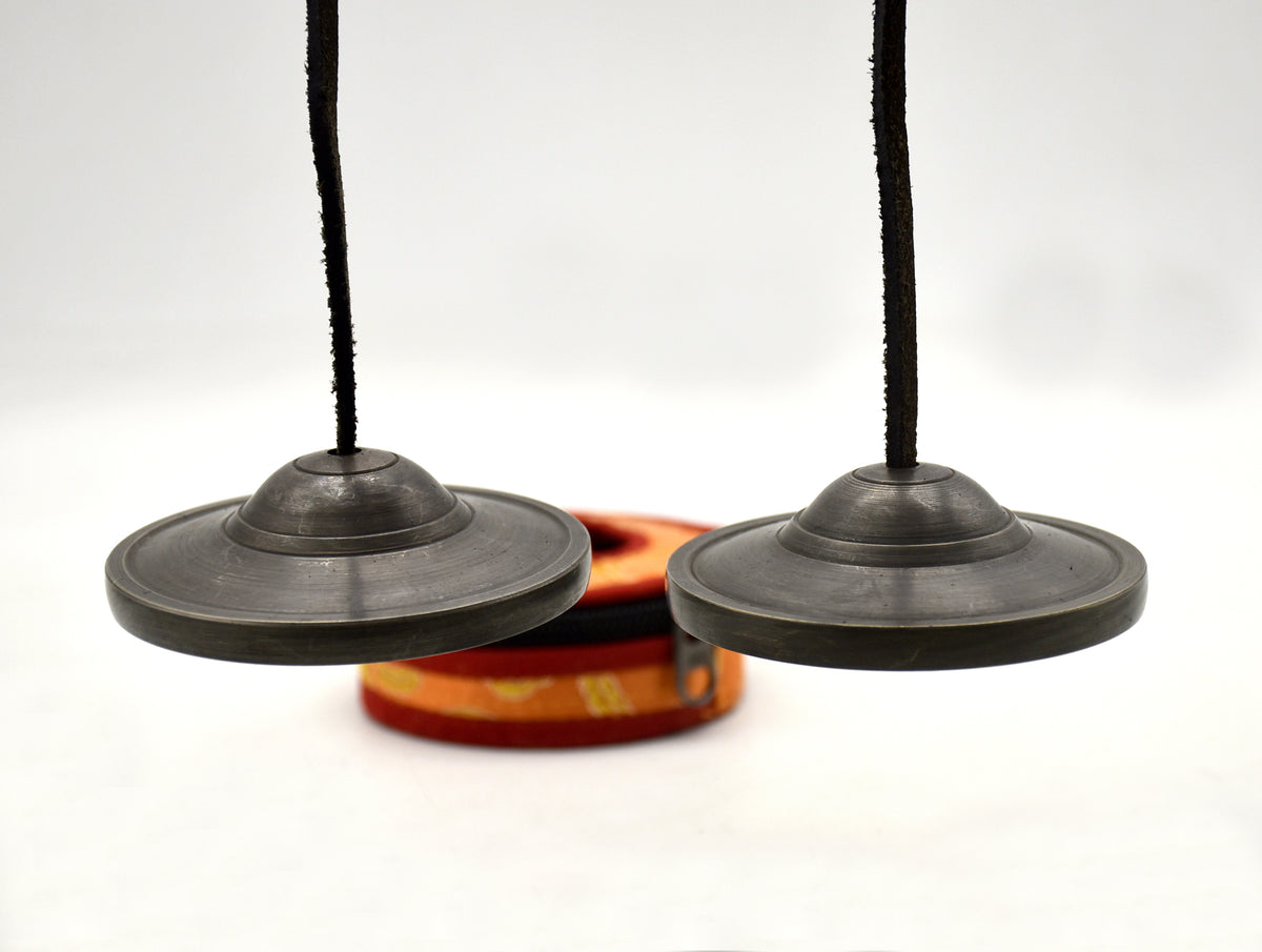 Antique bronze Tingsha cymbal pair connected by leather string
