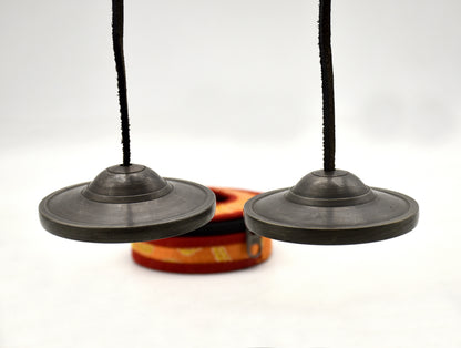 Antique bronze Tingsha cymbal pair connected by leather string