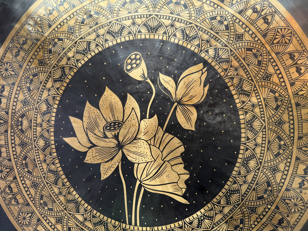 Close-up of lotus artwork on meditation gong