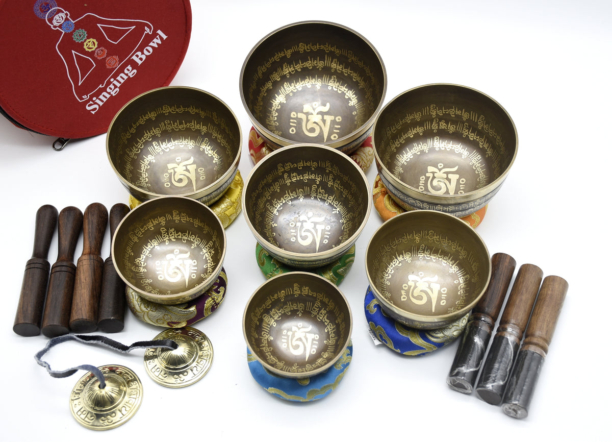 Mantra-carved Tibetan singing bowl set of seven with mallets, cushions and carrying case